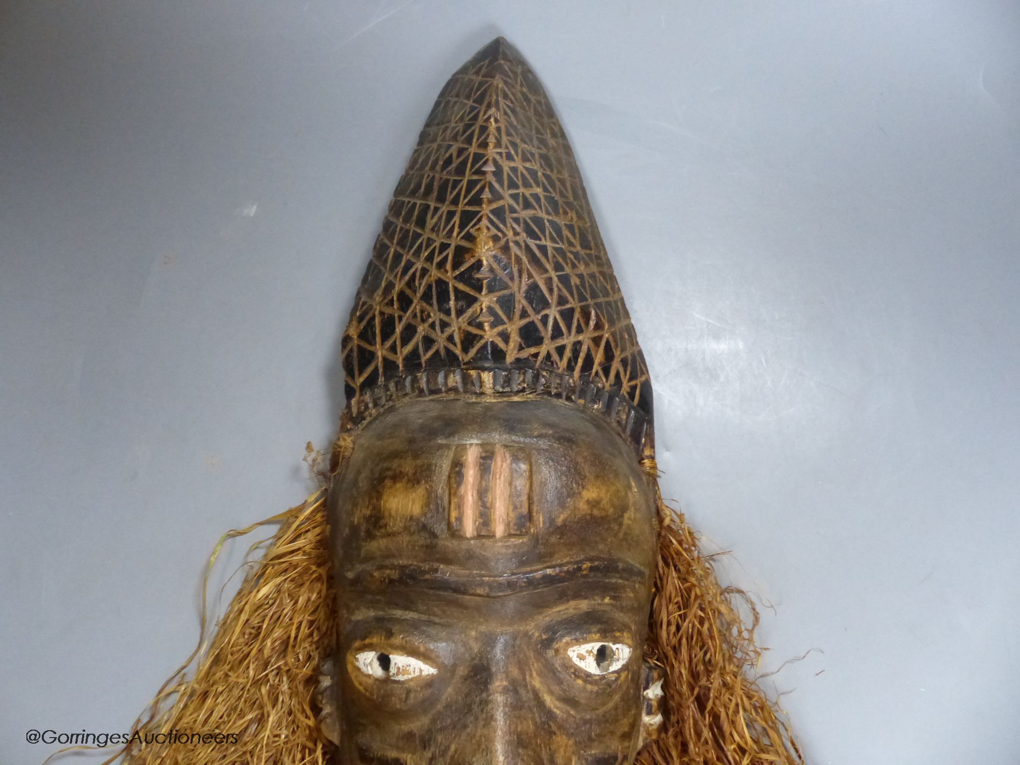A Bapende tribal carved wood mask, 41cm high
